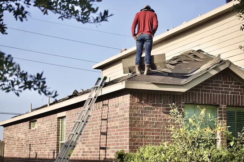 Professional roofer working on a residential roof in Finn Farm